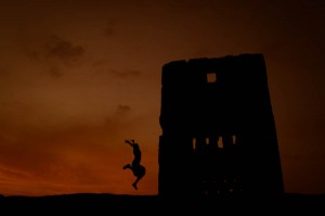 girl jumping at merind tombs fes morocco