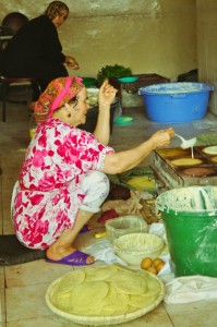 budget-travel-tip-backpacking woman cooking in Morocco